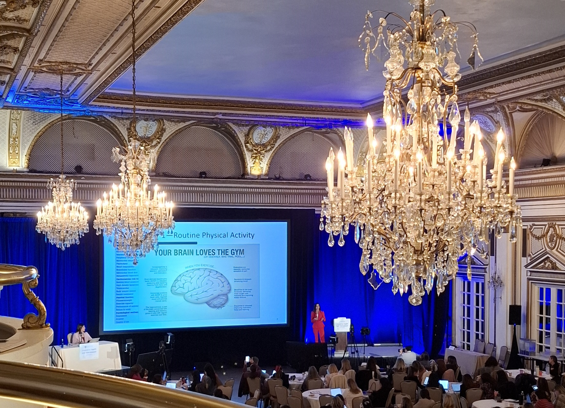 Conference hall with a slide reading 'Your brain loves the gym'